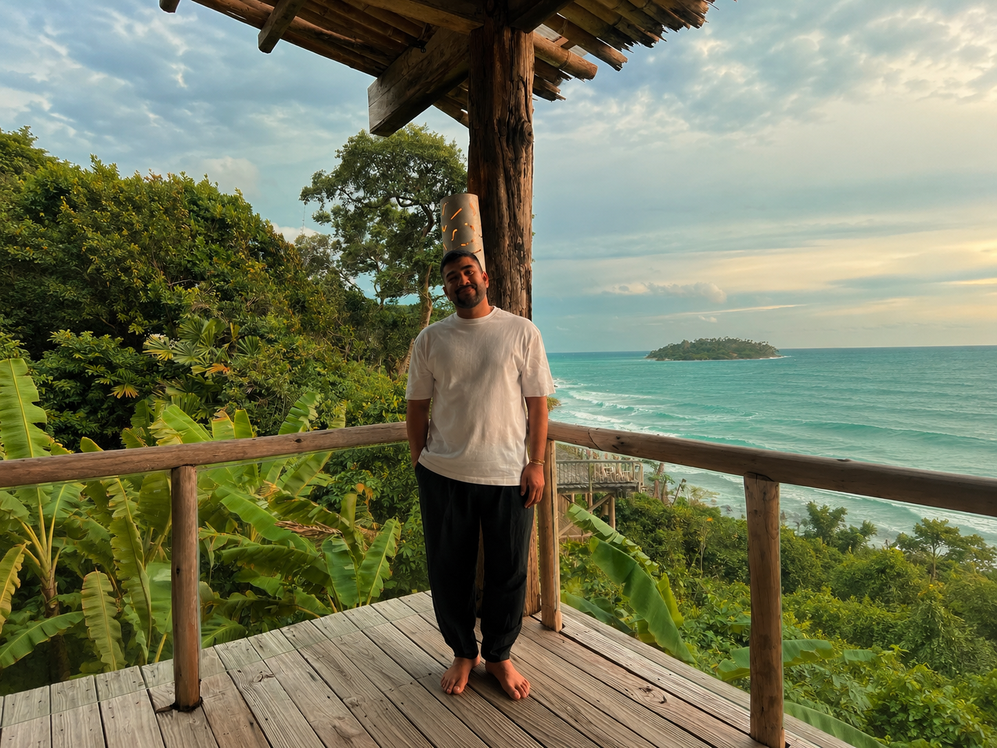 Neshi standing on a wooden deck overlooking the ocean